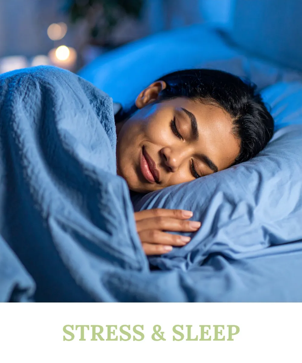 A peaceful woman sleeping soundly under a blue blanket, symbolizing the importance of restful sleep and stress management with Sihat365.